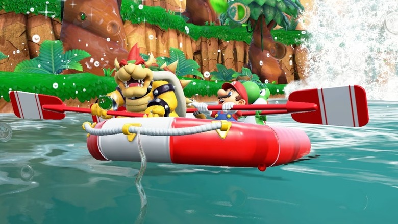 Bowser se sienta en una balsa remando contra Mario y Yoshi en Super Mario Party